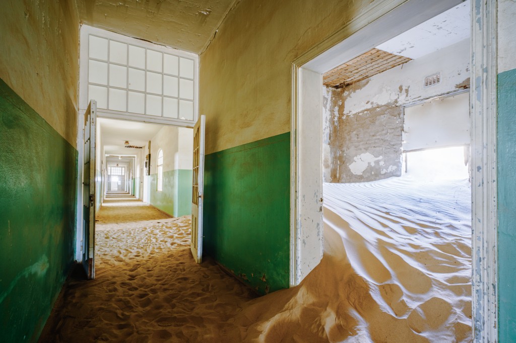 The Kolmanskop Ghost Town provides an eerie backdrop for early morning photography.