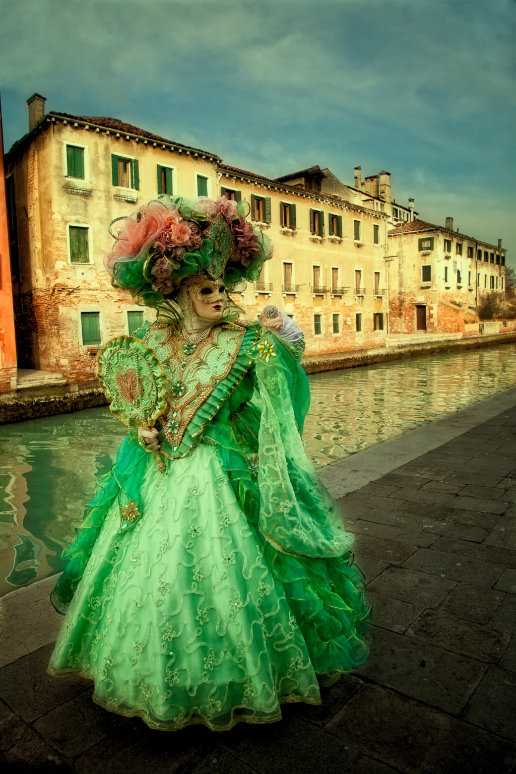 Green costumed Carnival model on Burano Island in Venice