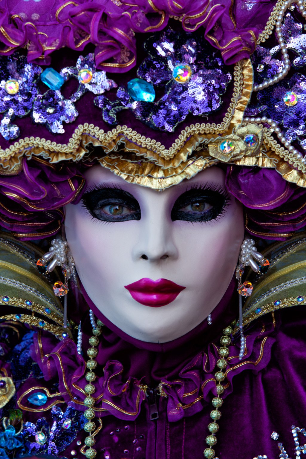 Close-up portrait of a gorgeous Carnival model in a bright purple costume