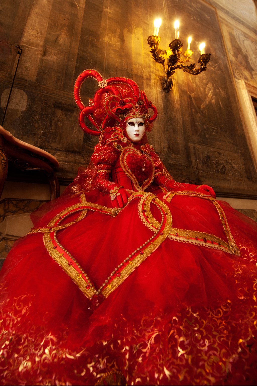 Bright red Carnival costume in a Venice palace