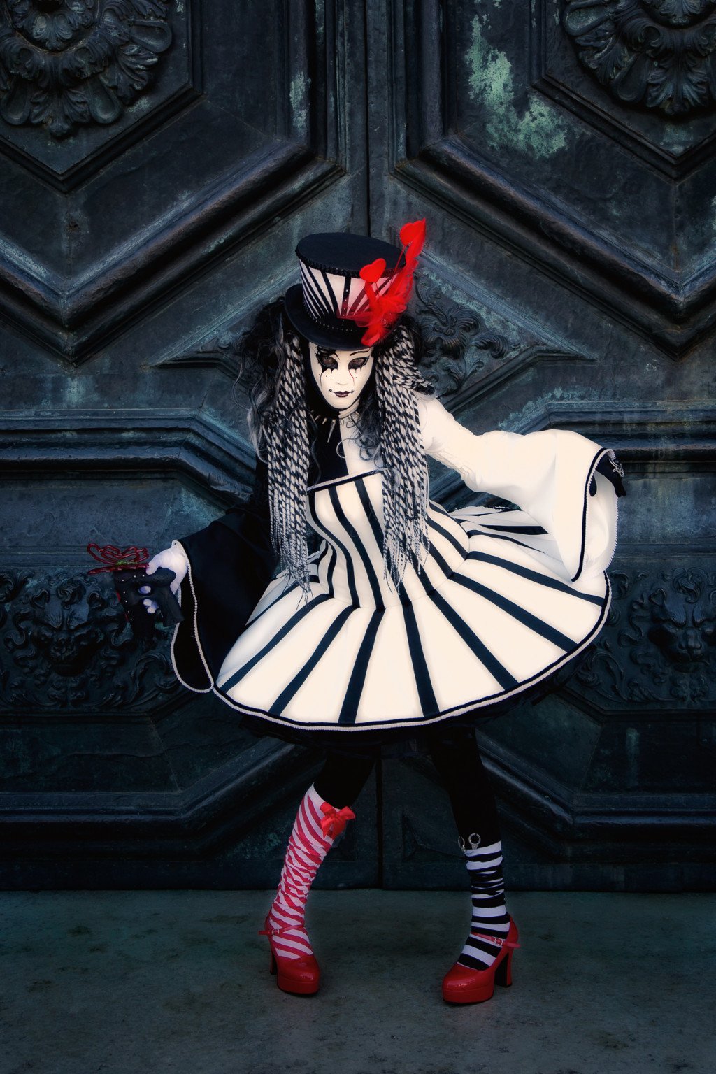 Carnival model in black, white and red in front of a church door