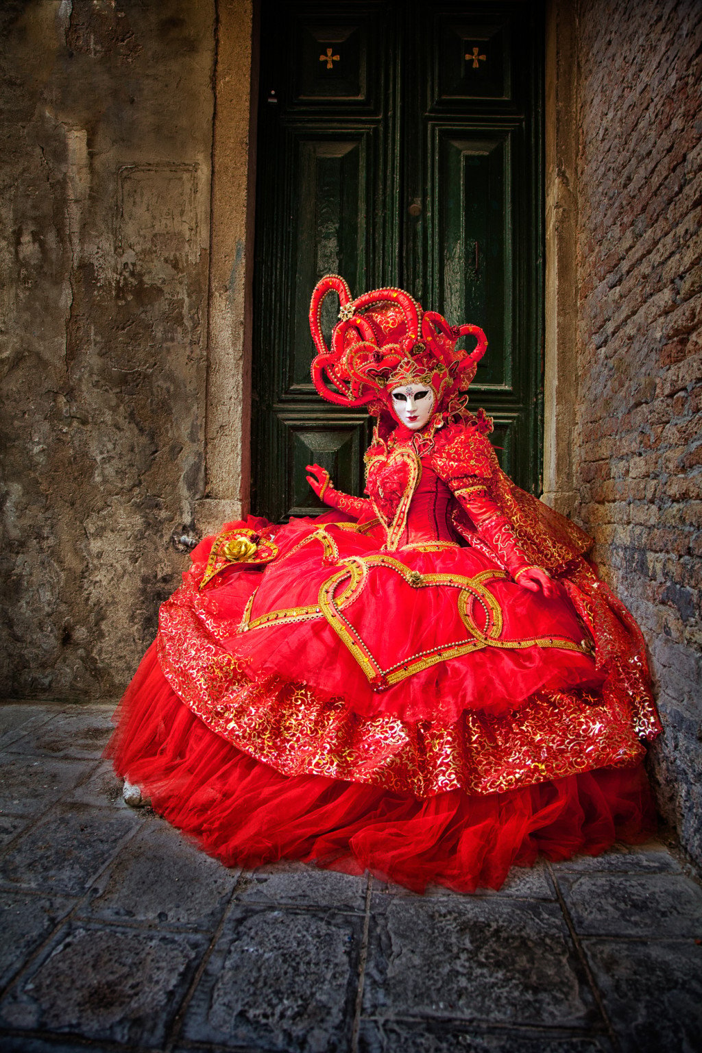 Red costumed model in a Venice doorway during the Carnival celebration