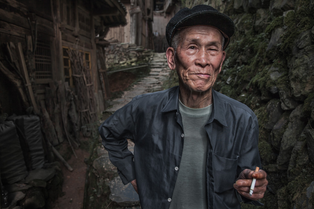 Chinese man from the Longji area takes a break outside his house. He was a natural model who had great expressions.