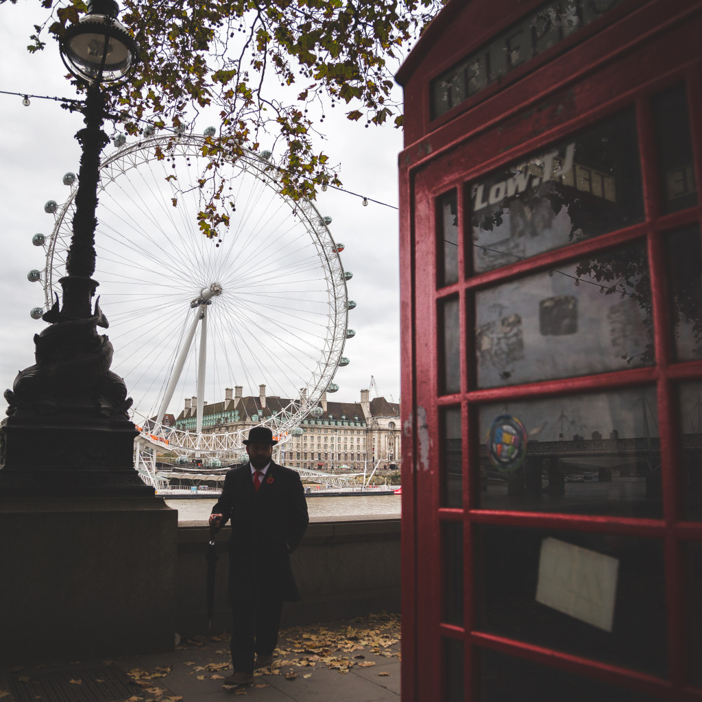 London Eye and a iconic English red telephone box in London. The red telephone box, a telephone kiosk for a public telephone designed by Sir Giles Gilbert Scott, was a familiar sight on the streets of the United Kingdom, Malta, Bermuda and Gibraltar.