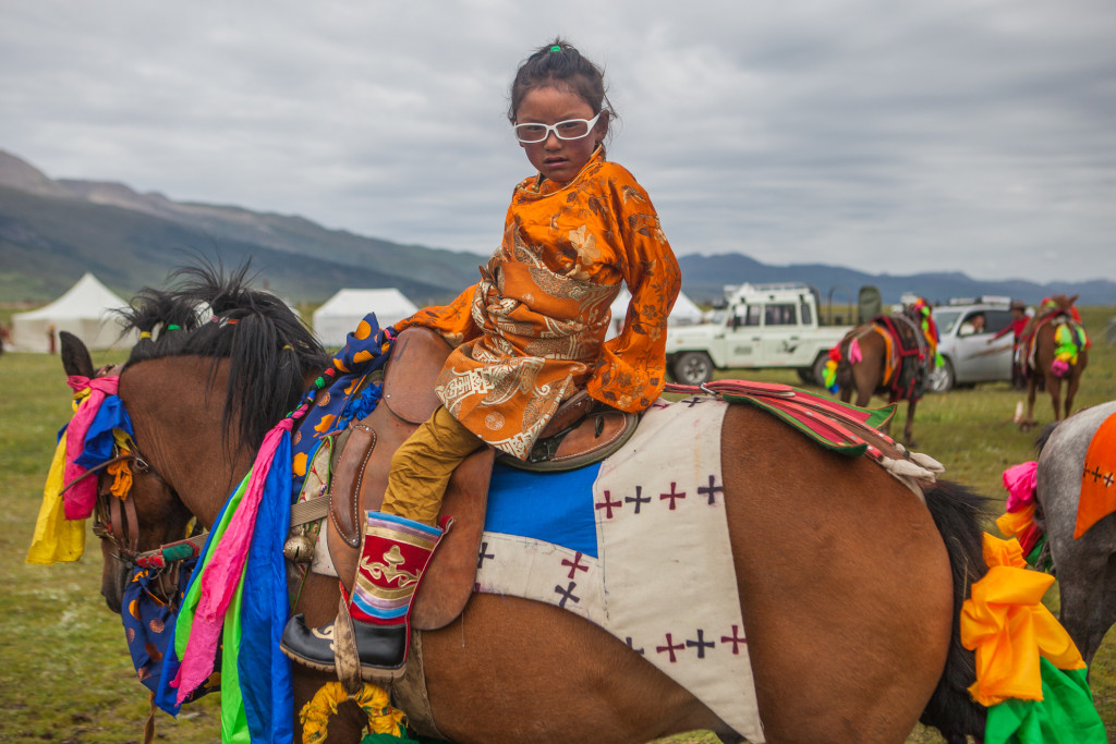 young-tibetan-girl-on-her-fathers-racing-horce_10379467804_o