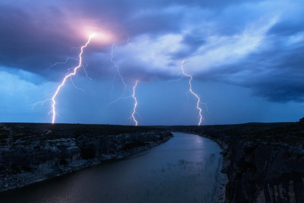 Three bolts strike in the hills north of where Highway 90 crosses the Pecos River.